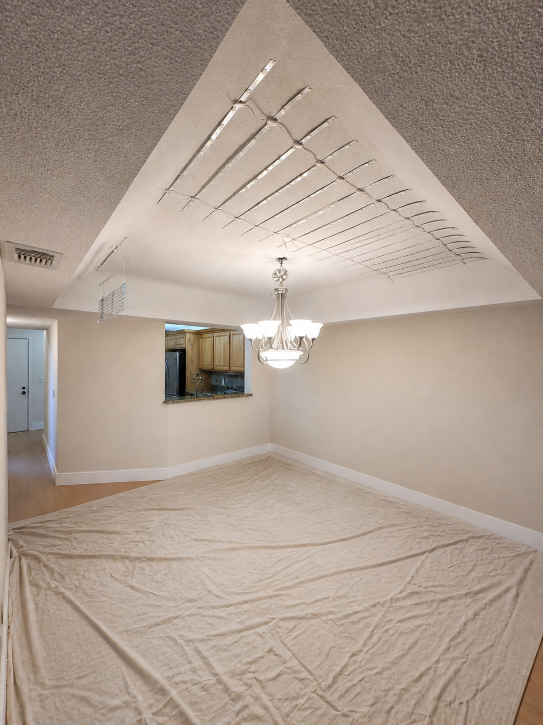Dining area in progress showing LED grid framework prepared for the luminous stretch ceiling installation
